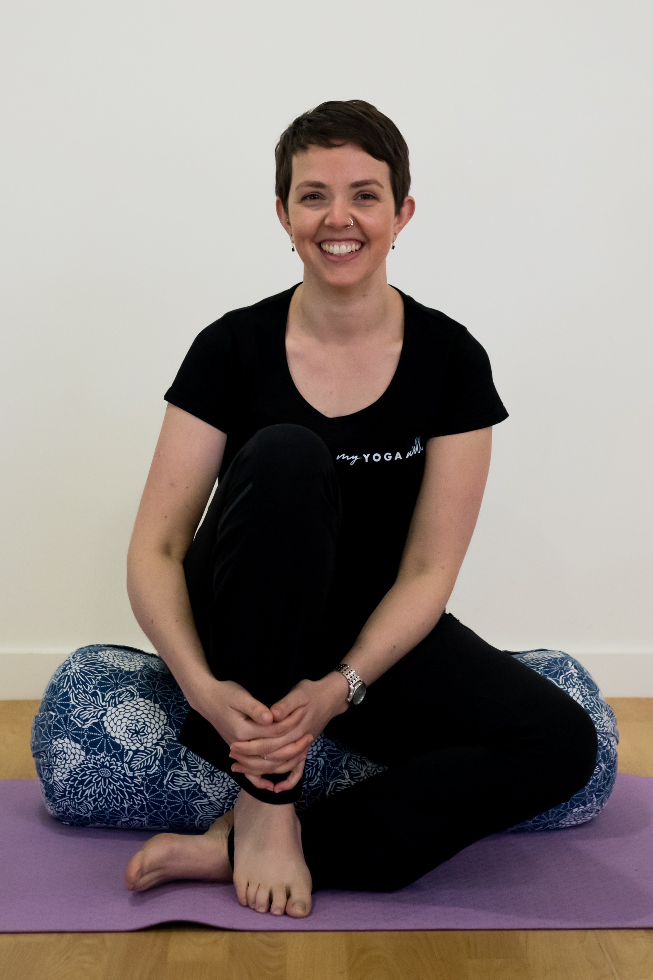 Alison sitting cross legged smiling